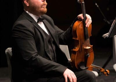A Conroe Symphony Orchestra Member with a Violin