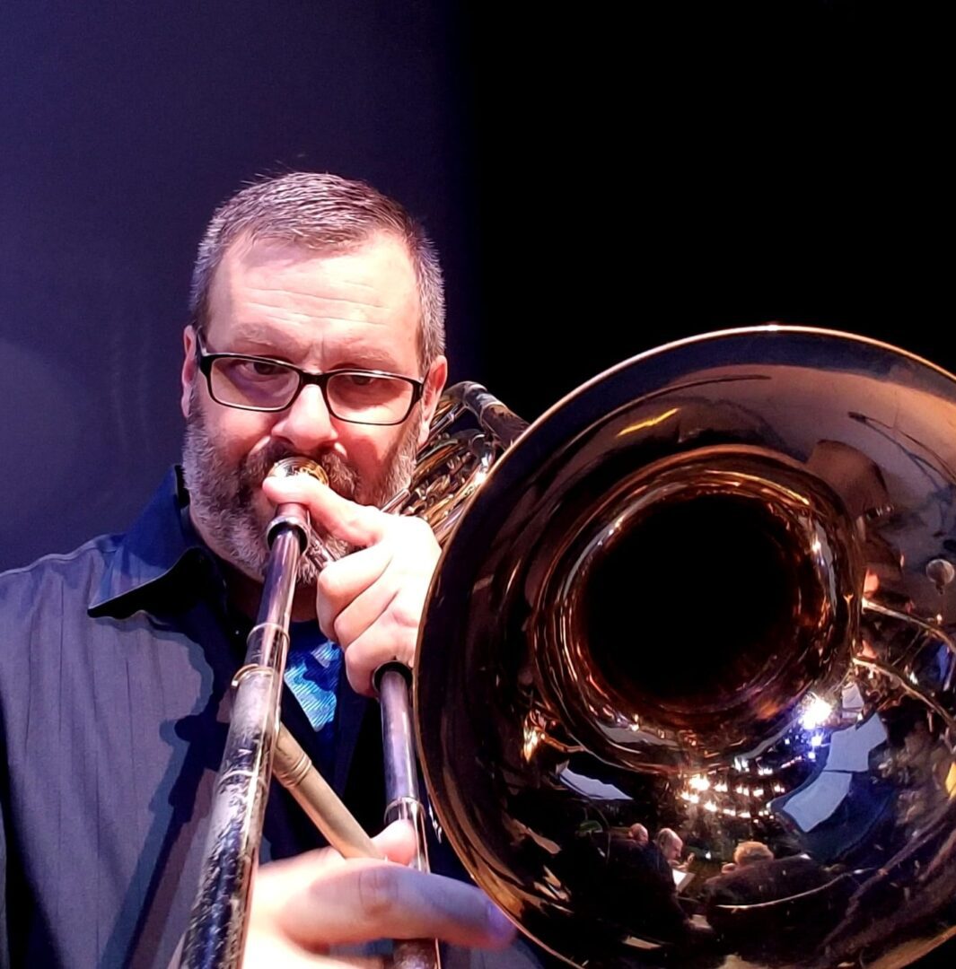 Noel Freeman Holding a Trumpet in the Store