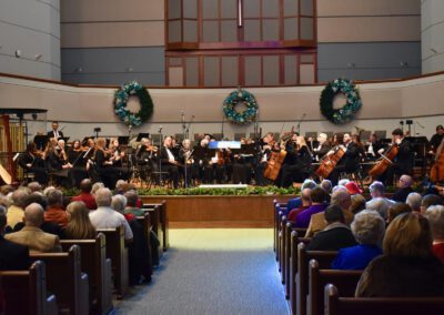 A choir and orchestra perform in a church.